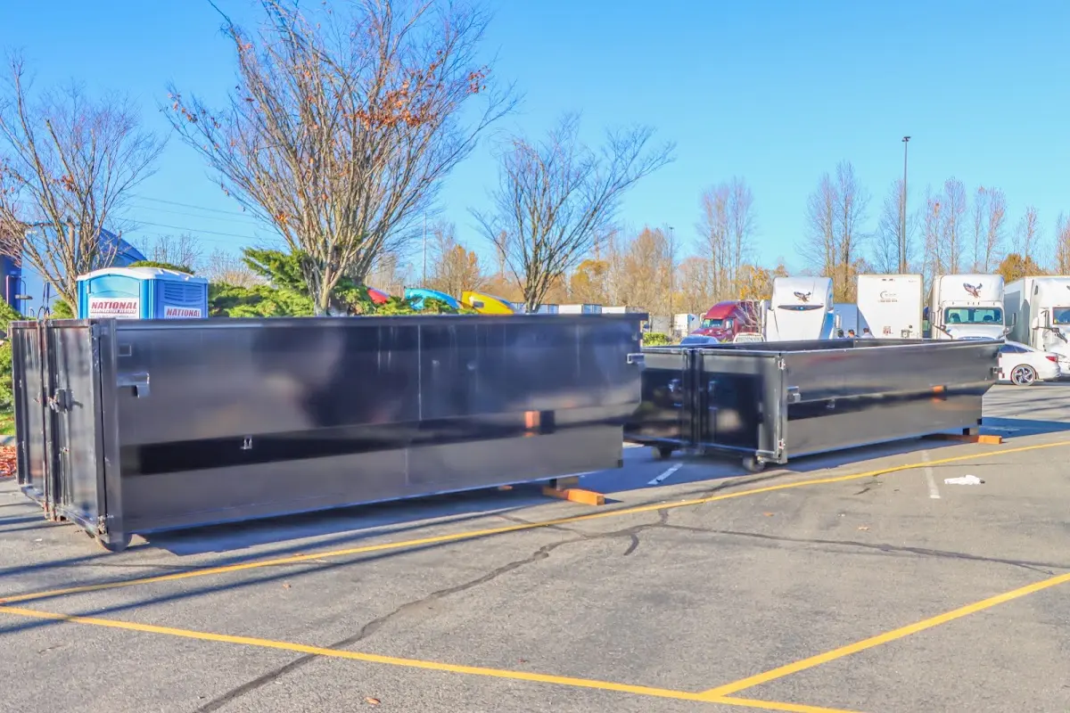 Professional dumpster rental service with roll-off container on residential driveway in Bridgton